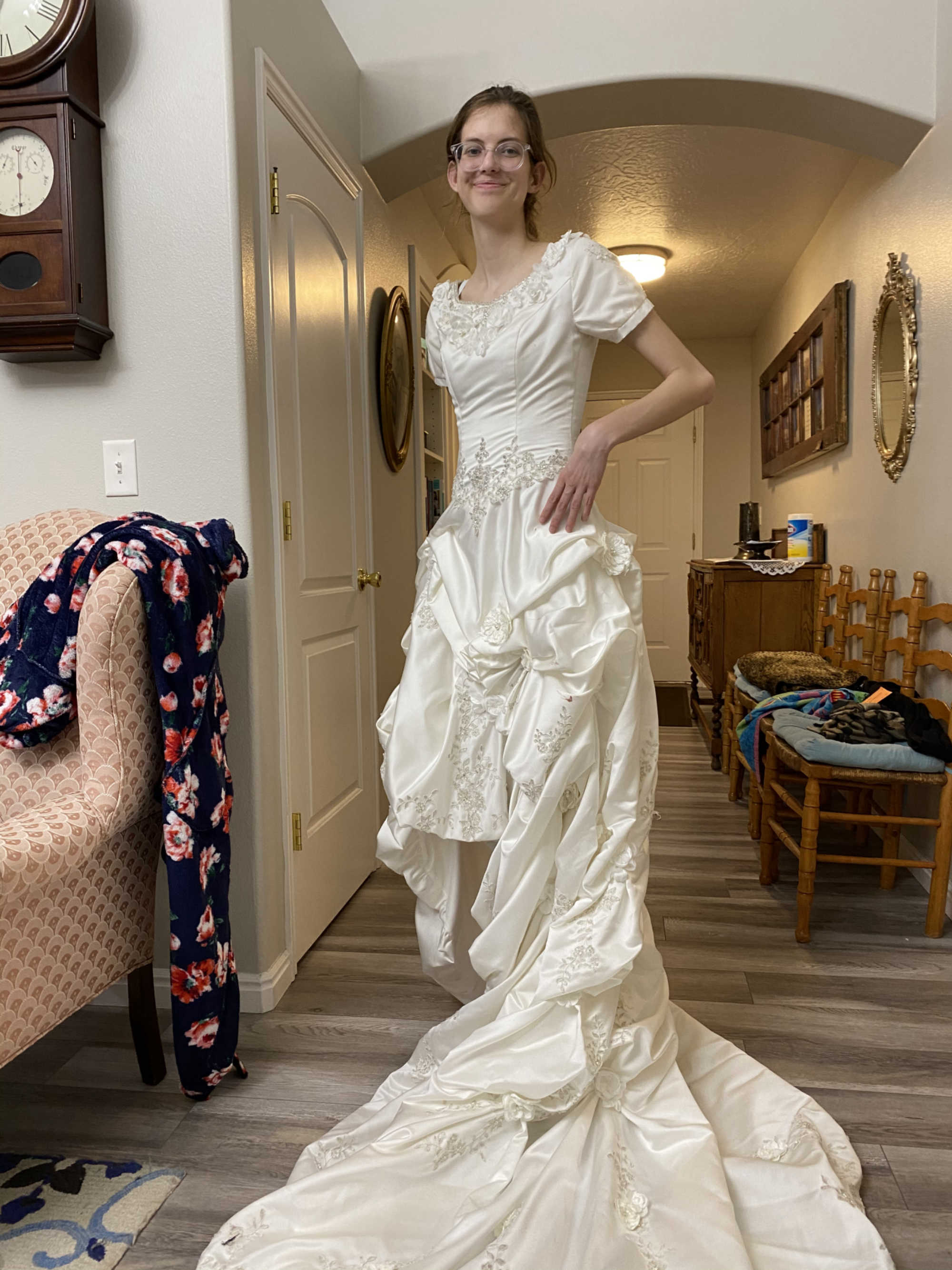 A young woman modeling a secondhand wedding dress bought at Deseret Industries.